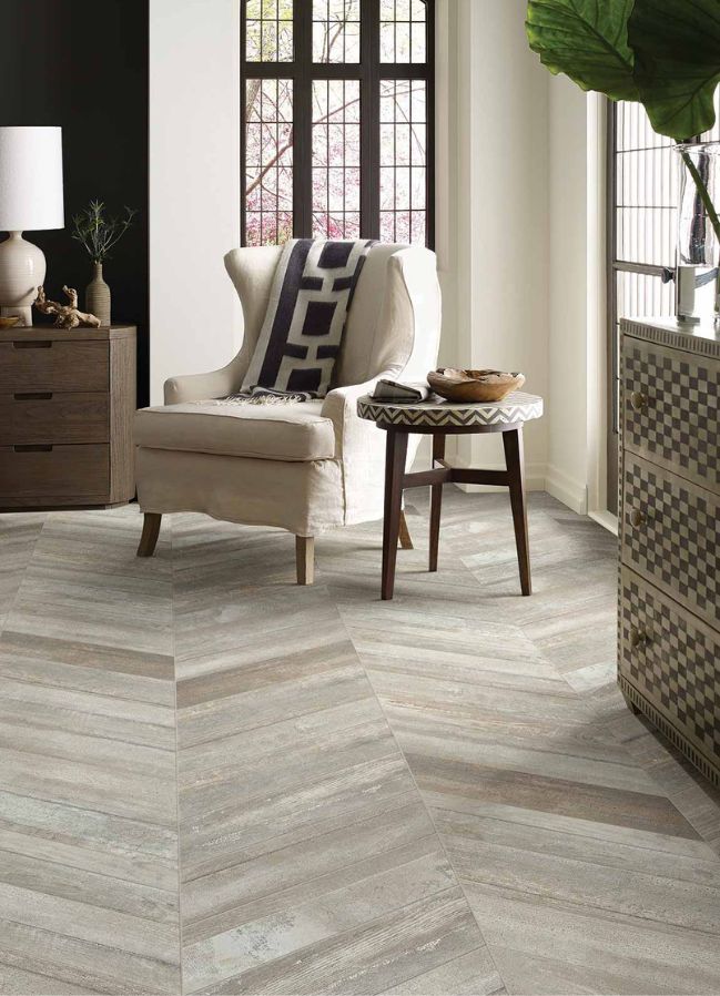 wood look tile flooring in a living room with large windows